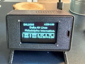 Flight information device showing DAL2688 for Delta Air Lines to Philadelphia International; speed 385, heading 310, altitude 12.5k, vertical speed +2.5k (AZ20-100).