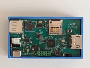 Blue plastic enclosure houses a green PicoTop development board with two USB ports (A), a microSD slot, and a Raspberry Pi-like processor; labeled '7West PicoTop'.