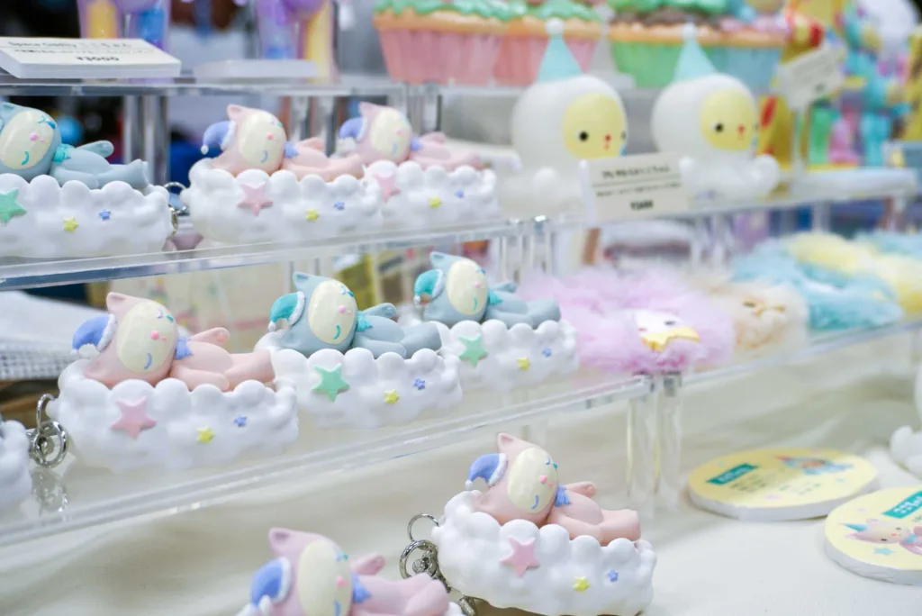 Pastel plush bunny toys arranged on cloud-shaped trays in a store display.