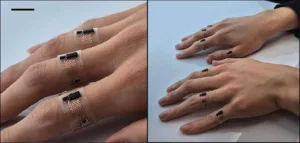 Close-up of hands wearing skin-mounted flexible sensors on the fingers, with transparent bands and copper zigzag traces on the joints on the left panel.