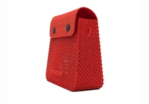 Red 3D-printed lattice tote bag with a curved top flap and two snap buttons, displaying the word STAY