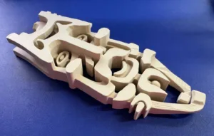 3D-printed cutaway model of a handgun showing internal components on a blue surface