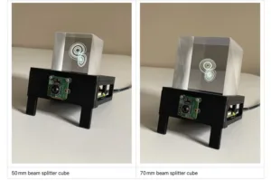 Two views of a 50 mm beam-splitter cube on a black stand with a green circuit board and translucent top, showing a circular inner pattern.