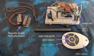ESP32-based wireless control: breadboard with receiver, status LED, magnetic switch, and orange wires; 433 MHz remote nearby.