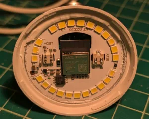 Circular LED light module with yellow SMD LEDs arranged around a central ESP32-based controller; likely the core of a smart light bulb