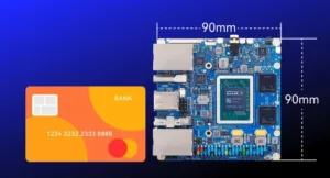 Orange bank card placed next to a blue single-board computer to illustrate a 90mm by 90mm footprint.