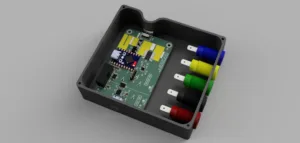 Electronic control module: black plastic case housing a green circuit board with five color-coded connectors on the side (blue, yellow, green, black, red).